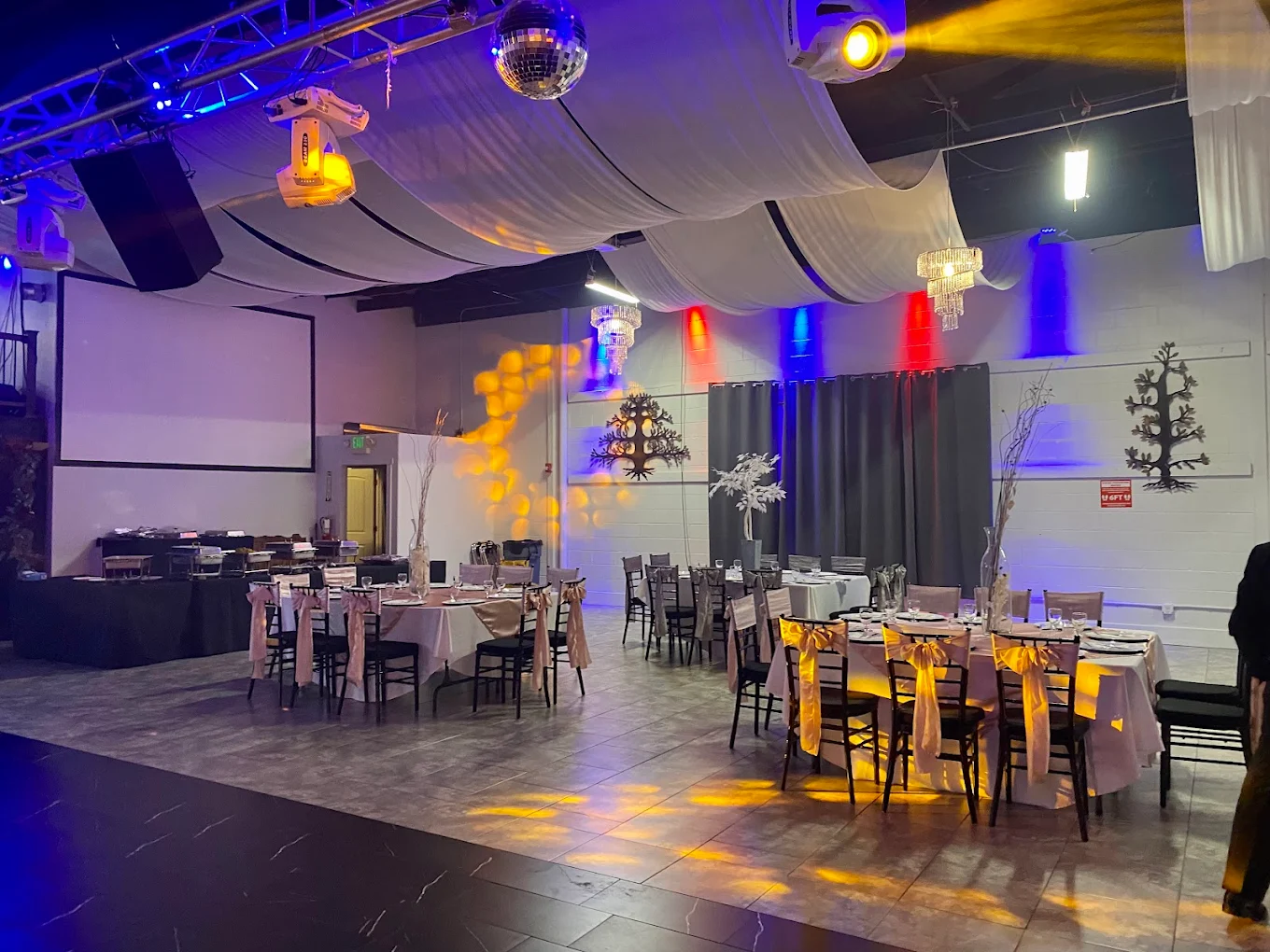 A beautifully decorated event hall for a wedding reception